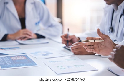 Team, medical analysts and doctors consulting with paperwork of graphs, data and charts in hospital conference room. Closeup of healthcare staff discussing statistics, results and innovation strategy - Shutterstock ID 2198714763
