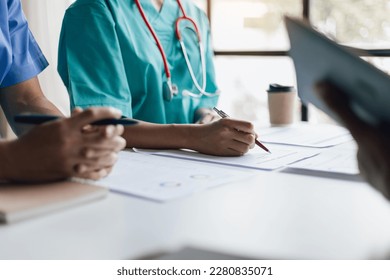 Team  medical analysts   doctors consulting and paperwork graphs  data   charts in hospital conference room  Healthcare staff discussing statistics  results research   innovation 