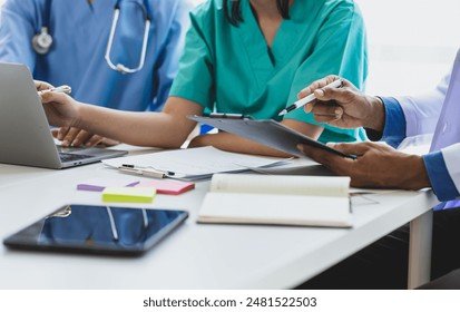 Team, medical analysts and doctors consulting with paperwork of data and charts in hospital conference room. Healthcare staff discussing statistics, results of research and innovation. - Powered by Shutterstock