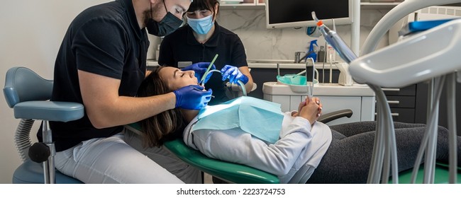 team of medical dentists in a dental office talking to a patient and preparing for treatment. treatment of the patient's teeth. brushing teeth - Powered by Shutterstock