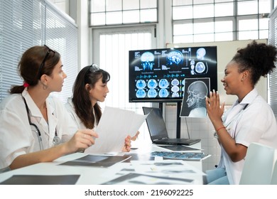 Team of medical doctor meeting in the brain research laboratory by monitor showing MRI, CT scans brain images. Group of female doctor discussing surgery and treatment with medical x-ray scan papers - Powered by Shutterstock