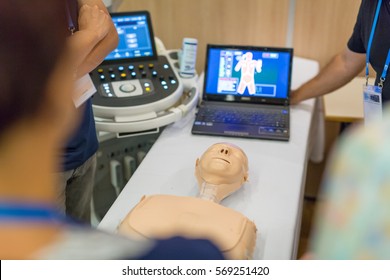 Team Of Medical Doctor Students Learning To Do Advanced Medical Examination Of Patient With Ultra Sound Scanner Machine On Ultrasound Techniques Workshop.