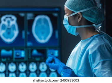 Team of medical doctors performs surgical operation in modern operating room using high-tech technology. Surgeons are working to save the patient in the hospital. Medicine, health and science. - Powered by Shutterstock