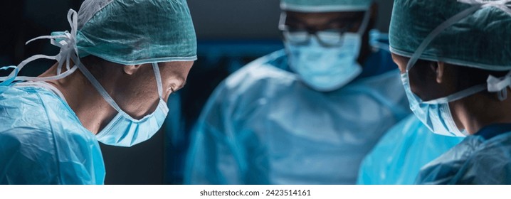 Team of medical doctors performs surgical operation in modern operating room using high-tech technology. Surgeons are working to save the patient in the hospital. Medicine, health and science. - Powered by Shutterstock