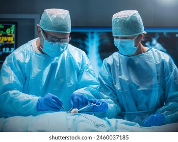 Team of medical doctors performs surgical operation in modern operating room using high-tech technology. Surgeons are working to save the patient in the hospital. Medicine, health and science. - Powered by Shutterstock