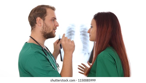 Team of Medical Doctors Talking and Examing Pulmonary X-Ray Result With White Background