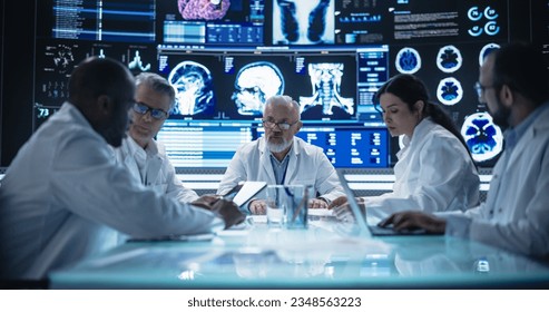 Team of Medical Professionals Having a Meeting in a Research and Development Science Laboratory. Diverse Group of Scientists Discussing New Trial Drug Treatment Results on Big Digital Screen - Powered by Shutterstock