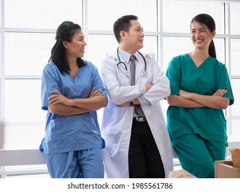 Team Of Medical Staff Wearing Uniform Having Fun Chatting During Breaks In The Hospital Boardroom.