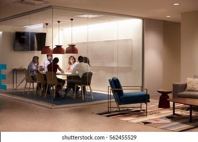Team in a meeting cubicle at a big corporate business