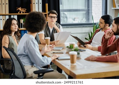 Team members collaborate during a critical work discussion. - Powered by Shutterstock