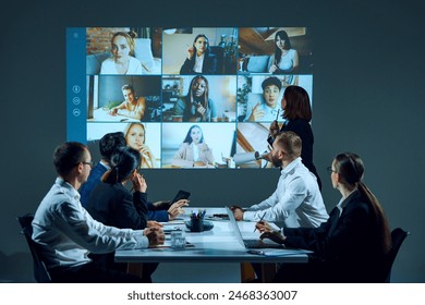 Team members meeting in boardroom, collaborating on tasks and sharing progress during virtual meeting. Online conference with colleagues. Concept of business, entrepreneurship, communication, teamwork - Powered by Shutterstock