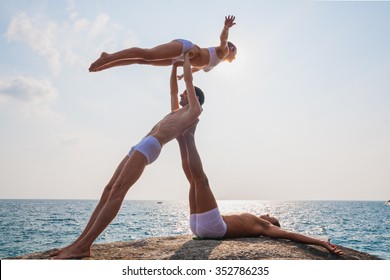 Team Members Performing Acro Yoga