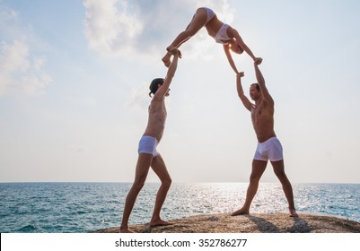 Team Members Performing Acro Yoga