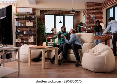 Team Of Men Losing Video Games Competition On Television Console, Feeling Sad And Frustrated About Lost Game Play. People Gathering At House Party With Snacks And Beer Bottles For Leisure.