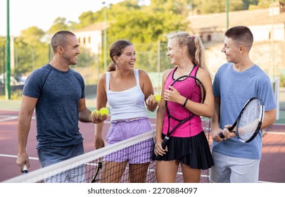 Team of men and women after playing tennis on the tennis court - Powered by Shutterstock