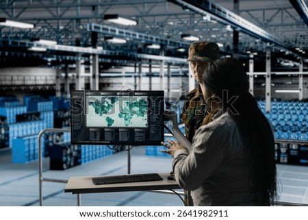 Team of military experts in data center examining mission coverage zones on global mapping software. Army units in server farm confirming strategic priorities using interactive geographic display
