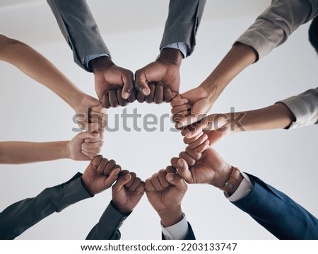 Team, motivation and support with hands fist bump of corporate partnership office workers. Work community, goal success and collaboration hand sign of business employee group teamwork together