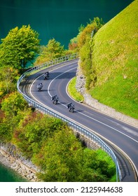 A team of motorcyclists travels the beautiful roads in the summer. The road and the turns. Traveling on a motorcycle. Recreation and active life.