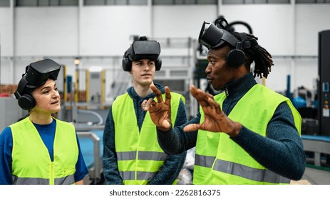 Team of multiracial engineers having a simulation experience with futuristic virtual reality glasses inside robotic factory - Tech industry and metaverse concept - Powered by Shutterstock