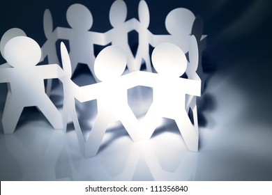 Team Of Paper Doll People Holding Hands In A Circle