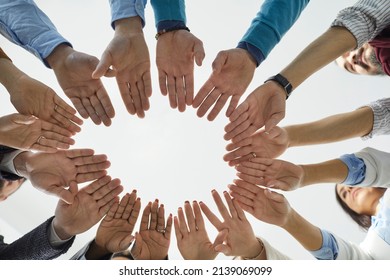 Team Of People Joining Hands. Diverse Group Of Business People Standing In Circle And Putting Their Hands Together. Shot From Below, Cropped Shot, Close Up. Teamwork, Unity, And Partnership Concepts