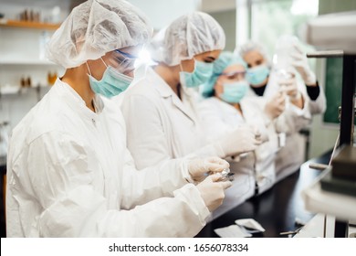 Team Of Pharmacist Working On Drug Discovery.Development Of New Vaccine.Sterile Cleanroom.Antivirus Antidote Immunization Concept.Lab Pre-clinic Experiment.Disease Biochemical Analyisis.Diagnostics