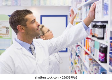 Team Of Pharmacists Looking At Medicine At The Hospital Pharmacy