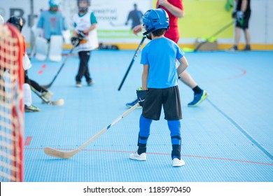 Team players having competitive hockey game outdoors