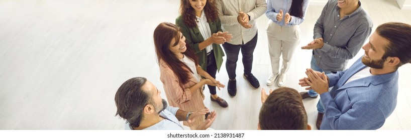 Team Of Positive Businessmen And Businesswomen Standing In Circle And Giving Round Of Applause To Each Other. Banner, View From Above, Overhead, High Angle. People, Success, Group Recognition Concept