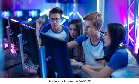 Team of Professional Boys and Girls Gamers Actively Thinking/ Discussing Game Strategy/ Tactic, They're In Internet Cafe or on Cyber Games Tournament.