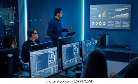 Team of Professional IT Developers Have a Meeting, Speaker Shows Growth Data with Graphs, Charts, Software UI. Shown on TV. Concept: Software UI Development, Deep Learning, Graphs, Charts.