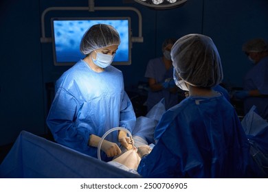 Team of professional doctors performing operation in surgery room - Powered by Shutterstock