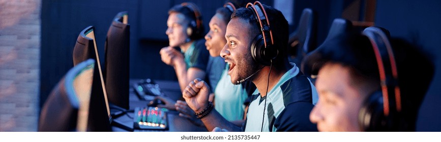 Team Of Professional Esport Gamers With Happy Man In Focus Playing In Video Games On Cyber Games Tournament Indoors