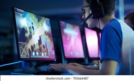 Team of Professional eSport Gamers Playing in Competitive  MMORPG/ Strategy Video Game on a Cyber Games Tournament. They Talk to Each other into Microphones. Arena Looks Cool with Neon Lights. - Shutterstock ID 705666487