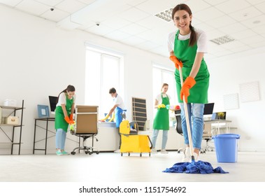 Team Of Professional Janitors In Uniform Cleaning Office