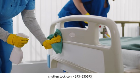 Team of professional janitors using equipment disinfecting hospital ward. Nurses in uniform cleaning furniture in empty clinic room. Healthcare and hygiene concept - Shutterstock ID 1934630393