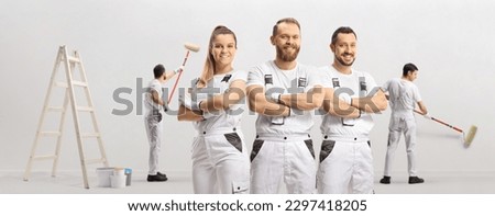 Team of professional painters painting a wall