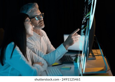 Team Of Professionals Analyzing Data On Interactive Screen In Office. Collaboration, Innovation, Technology.