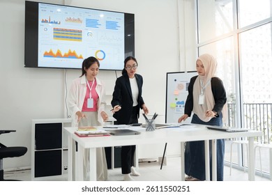 Team of professionals analyzing data report on dashboard during meeting in modern office setting