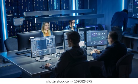 Team of IT Programers Working on Desktop Computers in Data Center System Control Room. Team of Young Professionals Working In Software and Hardware Development, Doing Coding - Powered by Shutterstock