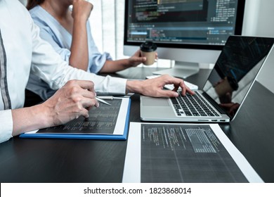 Team of Programmer working in software javascript computer in IT office, Writing codes and data code website and coding database technologies to find solution to problem.