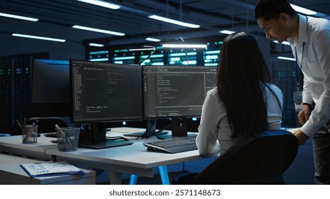 Team of programmers in data center responsible for installation and repair of networking equipment solving tasks. Teamworking colleagues doing maintenance on server room infrastructure, camera B