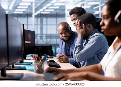 Team of programmers in server farm upset after losing all data after hacker managed to pass firewall. Critical error alert on monitor in data center making IT staff members feel dejected