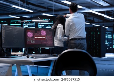 Team of programmers in server hub trying to protect hardware from hacker attack stealing sensitive information. Data center cybersecurity division coworkers fighting virus during security breach