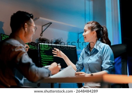 Team of programmers working late at night at a software development company, web developers, and coders working in the software company's office.