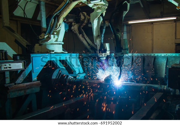 Team Robot welding movement Industrial automotive\
part in factory