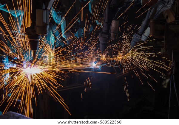 Team robots welding in car\
factory