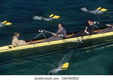 Team of rowers in business suits
