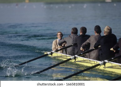 Team Of Rowers In Business Suits