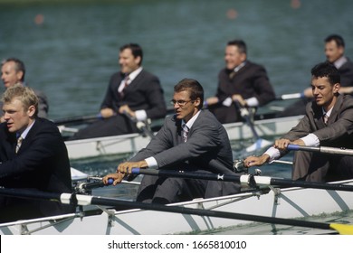 Team Of Rowers In Business Suits